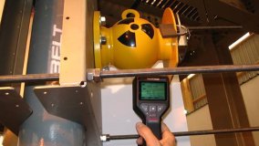 A nuclear gauge is used to take material density measurements